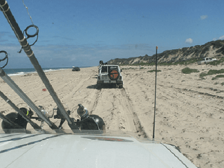 4WD's travelling on a seashore.