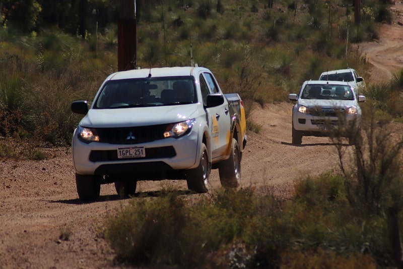 3 4WD's travelling on a sand track.