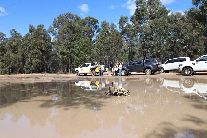 4WD stopping near a swamp due to a flat tyre.