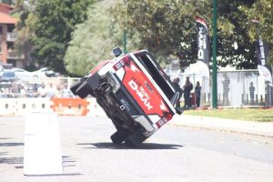 White and red coloured D-max doing tricks on a 4WD show.