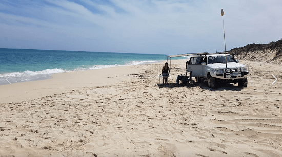 White coloured 4WD parked on a beach that represents "wilbinga conservation park" blog.