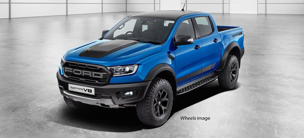 Blue coloured Ford Range Raptor V8 parked on a stock room.